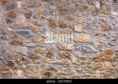 Stone wall texture background. Old stonewall traditional pattern building facade, natural material for cladding and flooring Stock Photo