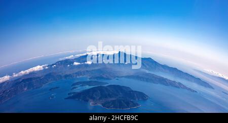 Curvature Of Planet Earth. Aerial Shot. Blue Sky And Clouds Over Island 