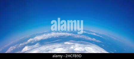 Curvature Of Planet Earth. Aerial Shot. Blue Sky And Clouds Over Island 