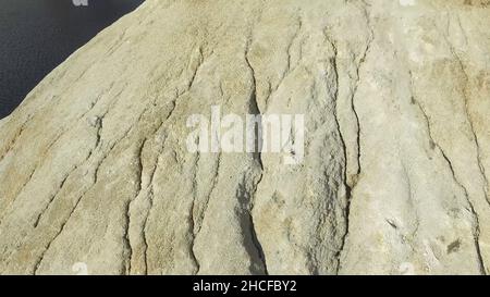 Close-up detail of rough cut miniature rocky cliffs. Nature and adventure concept. warm limestone texture. close up texture of grey stone with cracks. Stock Photo