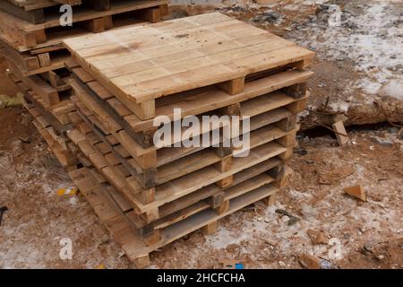 Stack wooden palle at a construction site. Empty wooden palle. Pallets for transportation of goods Stock Photo