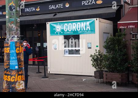 22.12.2021, Berlin, Germany, Europe - A mobile construction cabin serves as temporary station for a free corona rapid test on a pavement in Mitte. Stock Photo