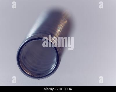 Close-up picture of a rusty gold and silver screw on a white background Stock Photo