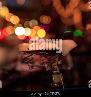 Selective focus shot of bicycle saddle with blurred bokeh background Stock Photo