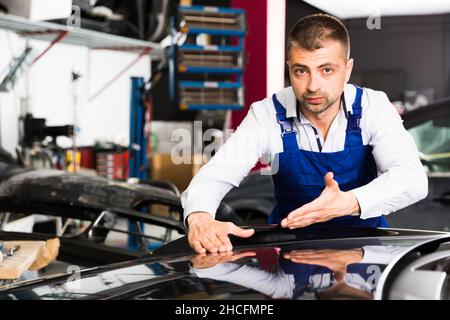 Car painter showing car after painting Stock Photo
