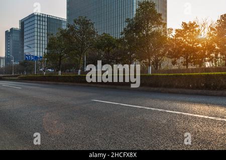city empty traffic road with cityscape in background Stock Photo