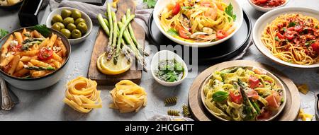 Pasta assortment on gray background. Traditional Italian Food concept. Panorama Stock Photo