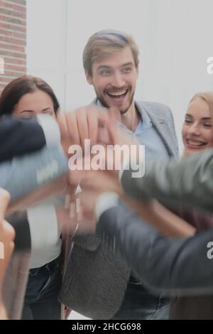 close up. happy business team joining their hands together. Stock Photo