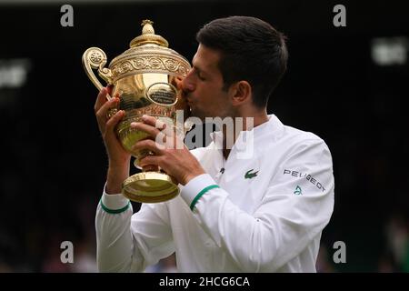 Beijing, China. 11th July, 2021. File photo taken on July 11, 2021 shows Novak Djokovic of Serbia celebrating with the trophy after winning the men's final match between Novak Djokovic of Serbia and Matteo Berrettini of Italy at Wimbledon Tennis Championship in London, Britain. Djokovic, 34, won his 20th Grand Slam men's singles title at Wimbledon, equalling Rafael Nadal and Roger Federer's joint record. He also claimed the men's singles championship at the Australian Open and French Open in 2021. Credit: Tim Ireland/Xinhua/Alamy Live News