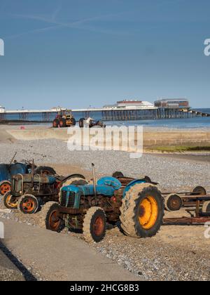 Fishermens tractors on the beach at sunny Cromer, Norfolk, England Stock Photo