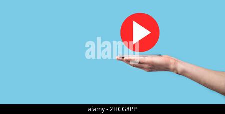Businessman pressing, hold play button sign to start or initiate projects.Video Play Presentation. Idea for business, technology.media player button. Stock Photo