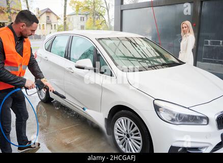 woman washing car with pressure washer at self-service car wash station,  selective focus Stock Photo - Alamy