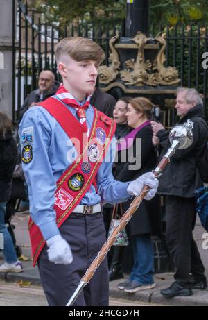 Young drum major holding a ceremonial mace leads the Kingston & Malden Scout & Guide Band at the Lord Mayor’s Show 2021, London, England. Stock Photo