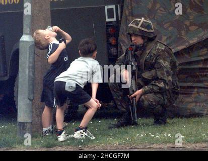 File photo dated 05/07/97 of a soldier in the Garvaghy Road talking to some local children, at a road block on the eve of the Drumcree Orange parade. An Irish Government official asked an NIO minister about speculation that the British Army was 'measuring' the Garvaghy Road in Portadown for bollards at the height of the marching dispute in 1997, according to newly released documents from the National Archives. Issue date: Wednesday December 29, 2021. Stock Photo