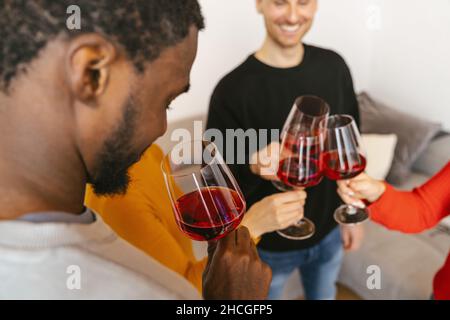 Happy friends having fun and drinking wine - Friendship concept with young people enjoying harvest time together at farmhouse vineyard countryside - W Stock Photo