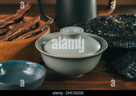 Bowl with brewed Chinese Lingzhi or Reishi mushroom on wooden table. Asian herbs for health. Herbal medicine. Stock Photo