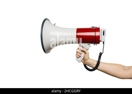 Man hand holding a Red and white bullhorn or megaphone in his hand, isolated on white background Stock Photo