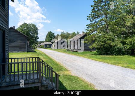 A row of old houses on either side of a dirt road in the Eckley Miners Village. Stock Photo