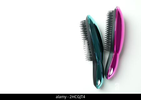 Colored plastic hair brushes on white background Stock Photo