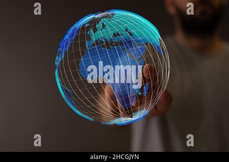 Closeup of the hand touching 3d rendered model of the globe. Stock Photo