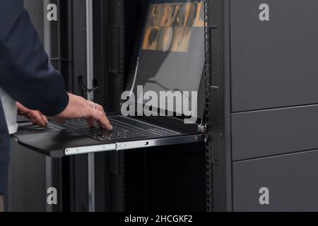 Data center engineer using keyboard on supercomputer server room Stock ...