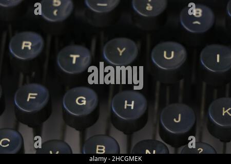 Close up of an old black typewriter keyboard with round keys. High quality photo Stock Photo