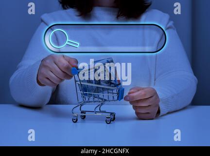 woman holds a metal tedeku with paper american dollars and a line for entering information search, online shopping, inquiry Stock Photo