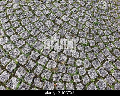 Cobbled stone background laid on a pathway with a rough circular brick texture pattern, stock photo image picture Stock Photo