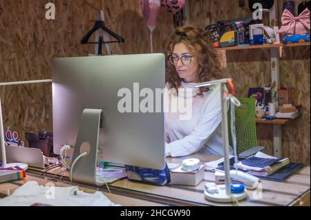 Business woman accountant designer works on computer in working office. Corporate person in technology company. Real life concept Stock Photo