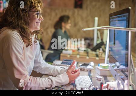 Business woman accountant designer works on computer in working office. Corporate person in technology company. Real life concept Stock Photo