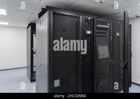 Data Center With Multiple Rows of Fully Operational Server Racks. Modern Telecommunications, Cloud Computing, Artificial Intelligence, Database Stock Photo