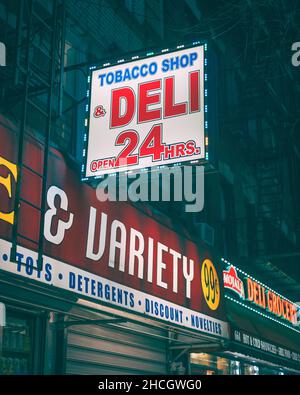 little italy tobacco Tobacco shop and deli sign at night, in The Bronxs Little Italy, New York  City Stock Photo