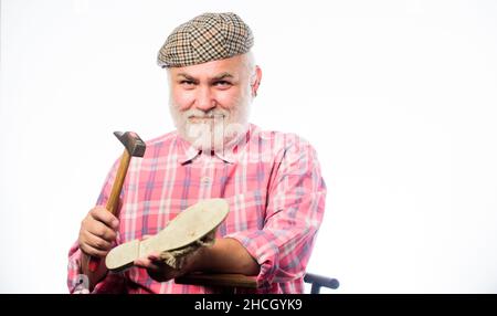 Fits perfect. shoemaker at work. mature shoemaker in workshop make shoes. Cobbler workmanship. shoemaker working with leather textile and hammer at Stock Photo