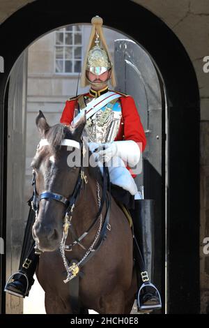 Mounted horseguard, member of the household cavalry on horse in uniform at Horseguards Parade, popular tourist destination, Whitehall, London, England Stock Photo