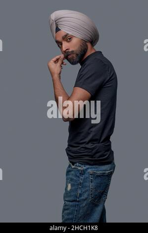 Calm Indian man in the headwear looking ahead Stock Photo
