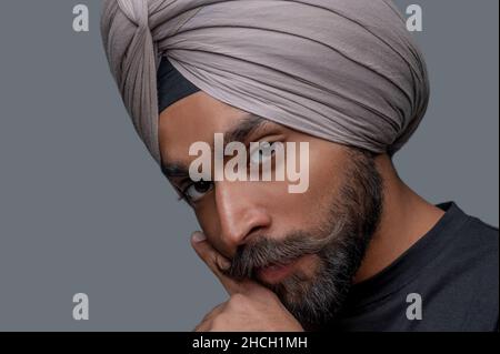 Tranquil man in the turban posing for the camera Stock Photo