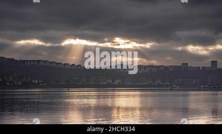Sun beams bursting through the clouds, over Penarth Marina, on the edge of Cardiff Bay, Wales Stock Photo