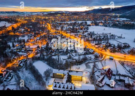 Drone View on Illuminated Zakopane at Dawn  in Winter. Stock Photo