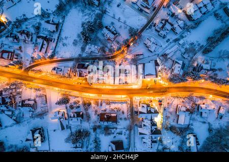 Illuminated Street in Winter Zakopane Town. Top Down Drone View. Stock Photo