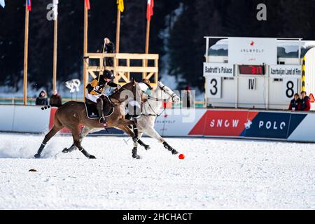 Juan Bautista Peluso (black) of Team Badrutt's Palace Hotel battles Santiago Marambio (white) of Team Azerbaijan Land of Fire, 36th Snow Polo World Stock Photo