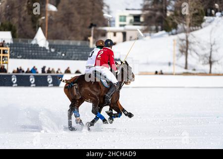 Robert Strom (red) of Team St. Moritz and Santiago Marambio (white) of Team Azerbaijan Land of Fire ride side by side across the field at full Stock Photo