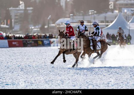 Nacho Gonzalez (4) of Team St. Moritz pursued by Elcin Jamalli (1) and Santiago Marambio (3) of Team Azerbaijan Land of Fire, 36th Snow Polo World Stock Photo