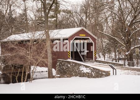 Zook's Mill Red Covered Bridge after a snowstorm in rural Lancaster County, Pennsylvania Stock Photo