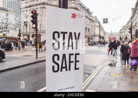 London, UK 17th December 2021. 'Stay Safe' signs with hand sanitisers have been installed in Oxford Street and Regent Street as the Omicron variant of COVID-19 spreads in the UK. Stock Photo