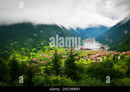 Greenery with stunning mountain lake with turquoise water with beautiful homes in mountains village Uzun Gol in Karadeniz Stock Photo