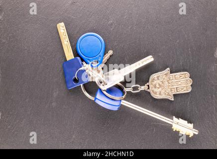 Bunch of keys with keychain on a shale stone, macro, top view. Stock Photo