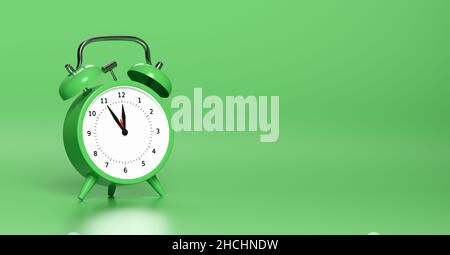 Green vintage alarm clock point to five minutes to twelve o'clock with bright Green background. Minimal creative concept, with copyspace for your indi Stock Photo