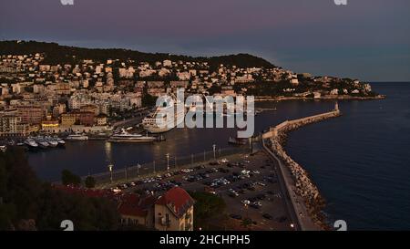 Panoramic view of harbour Port Lympia in the east of Nice, France at the French Riviera with cruse ship and residential buildings in the evening.