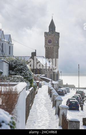 Porthleven Clocktower and Bay View Terrace sprinkled in snow after the beast from the east Stock Photo