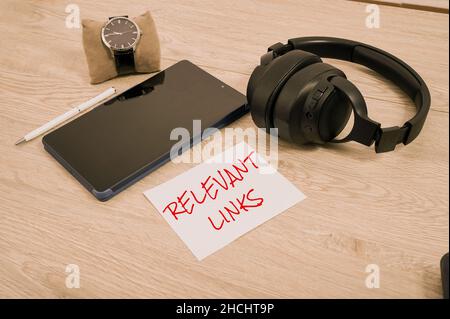 Hand writing sign Relevant Links. Concept meaning Significant sites for a particular topic Associated Blank Notebook Page With A Calculator And Stock Photo